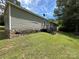 Charming home exterior with stone foundation, siding, green grass and wooded area at 9044 Forington Ln, Gastonia, NC 28056