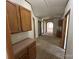 Hallway with carpeted floor and wooden cabinets at 9044 Forington Ln, Gastonia, NC 28056