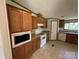 Traditional kitchen featuring wooden cabinets and white appliances at 9044 Forington Ln, Gastonia, NC 28056