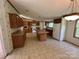 Traditional kitchen featuring wooden cabinets, island, and white appliances at 9044 Forington Ln, Gastonia, NC 28056