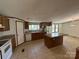 Traditional kitchen featuring wooden cabinets, island, and tile flooring throughout space at 9044 Forington Ln, Gastonia, NC 28056