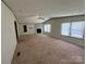 Bright living room showcases a fireplace, ceiling fan, and plush carpet at 9044 Forington Ln, Gastonia, NC 28056