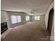 Spacious living room boasts ample natural light, ceiling fan, and gas fireplace at 9044 Forington Ln, Gastonia, NC 28056