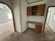 Home office space features a built-in desk, storage cabinets, and plush carpet at 9044 Forington Ln, Gastonia, NC 28056