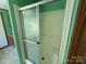 Bathroom featuring a functional shower with sliding doors and a view into the vanity area at 9044 Forington Ln, Gastonia, NC 28056