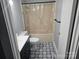 Bathroom features a shower-tub combination and black and white patterned flooring at 905 Klondale St, China Grove, NC 28023