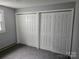Bedroom featuring a wall with double sliding door closets and neutral carpeting at 905 Klondale St, China Grove, NC 28023