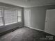 This bedroom features a large window for natural light and neutral carpeting at 905 Klondale St, China Grove, NC 28023