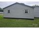 Exterior side view of the home shows gray vinyl siding and updated windows at 905 Klondale St, China Grove, NC 28023