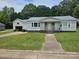 Charming single story home with manicured lawn, attached garage and sidewalk to street at 905 Klondale St, China Grove, NC 28023