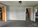 Open living room with updated light fixture, gray paint and carpet at 905 Klondale St, China Grove, NC 28023