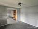 Open living room leading to kitchen with updated gray paint and carpet at 905 Klondale St, China Grove, NC 28023