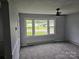 Living room with large window that lets in natural light and neutral carpeting at 905 Klondale St, China Grove, NC 28023