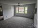 The living room has neutral carpeting and a large window that brings in natural light at 905 Klondale St, China Grove, NC 28023