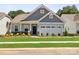 Charming single-Gathering home featuring a welcoming front porch and well-manicured lawn and two-car garage at 1029 Mapletree Ln, Indian Trail, NC 28079