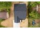 Birds eye view of the home showing the roof, yard, and driveway surrounded by lush greenery and a neighboring house at 105 Spring Garden Dr, Gastonia, NC 28052