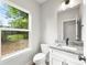 Well-lit bathroom features granite vanity top, white cabinetry, modern fixtures, and natural light at 105 Spring Garden Dr, Gastonia, NC 28052