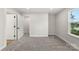 Bright bedroom with neutral colors, carpeted floors, and a large window providing natural light at 105 Spring Garden Dr, Gastonia, NC 28052