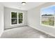 A bright bedroom features neutral walls, plush carpet, and natural light streaming through double windows at 105 Spring Garden Dr, Gastonia, NC 28052