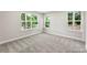 Spacious bedroom with soft carpet, neutral paint, and large windows offering serene views at 105 Spring Garden Dr, Gastonia, NC 28052