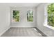 A bright bedroom space with two windows providing natural light, neutral walls and plush carpet at 105 Spring Garden Dr, Gastonia, NC 28052