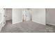 Carpeted bedroom with walk-in closet and ample natural light, offering comfort and convenience at 105 Spring Garden Dr, Gastonia, NC 28052
