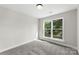 A bright bedroom featuring neutral walls, plush carpet, and natural light streaming through double windows at 105 Spring Garden Dr, Gastonia, NC 28052