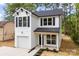 Charming two-story home with a white exterior, black shutters and a one-car garage at 105 Spring Garden Dr, Gastonia, NC 28052