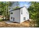 Two story home with white siding, a back patio and a small door to the back yard at 105 Spring Garden Dr, Gastonia, NC 28052