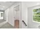 Upstairs hallway with carpeted floors, neutral walls, and a window offering natural light at 105 Spring Garden Dr, Gastonia, NC 28052