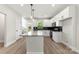 Modern kitchen with a large island, white cabinets, black backsplash and stainless appliances at 105 Spring Garden Dr, Gastonia, NC 28052