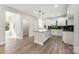 Modern kitchen with a large island, white cabinets, black backsplash and stainless appliances at 105 Spring Garden Dr, Gastonia, NC 28052