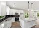 Kitchen boasts white cabinets, stainless steel appliances, granite countertops, and stylish pendant lighting at 105 Spring Garden Dr, Gastonia, NC 28052