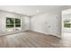 Light-filled living room with neutral walls, wood floors, and a view of the front yard at 105 Spring Garden Dr, Gastonia, NC 28052