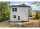 This home boasts a rear entry door and a simple concrete patio, perfect for private outdoor access at 105 Spring Garden Dr, Gastonia, NC 28052
