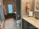 Bathroom with vanity and tile flooring, including a toilet and a glimpse of the glass enclosed shower at 1115 John Short Rd, Indian Land, SC 29707