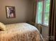 Comfortable bedroom with sunny window, brass bed frame, and floral patterned bedding at 1115 John Short Rd, Indian Land, SC 29707