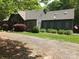 Well-maintained exterior with mature trees and established lawn at 1115 John Short Rd, Indian Land, SC 29707