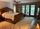 Spacious main bedroom with large windows and screened porch access, featuring a ceiling fan and plush rug at 1115 John Short Rd, Indian Land, SC 29707