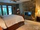 Bright main bedroom features a stone fireplace and large windows overlooking a scenic view at 1115 John Short Rd, Indian Land, SC 29707