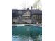 Relaxing backyard pool with stone trim and nice porch at 1115 John Short Rd, Indian Land, SC 29707