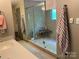 Bathroom with glass enclosed shower featuring a built-in bench and tiled walls at 1115 John Short Rd, Indian Land, SC 29707