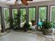 Bright sunroom with lots of plants and large windows overlooking the outside pool at 1115 John Short Rd, Indian Land, SC 29707