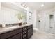 Well-lit bathroom featuring a double vanity with granite countertop, a large mirror, and a glass-enclosed shower at 124 Canada Dr # 45, Statesville, NC 28166