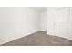 Empty bedroom with neutral carpet, white walls, and a closet with white doors at 124 Canada Dr # 45, Statesville, NC 28166