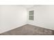 Unfurnished bedroom featuring plush carpeting, neutral walls, and a window at 124 Canada Dr # 45, Statesville, NC 28166