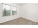 Bright bedroom features neutral carpet and large windows with blinds at 124 Canada Dr # 45, Statesville, NC 28166