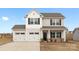 Charming two-story home with a two car garage, black shutters, and a well-manicured lawn at 124 Canada Dr # 45, Statesville, NC 28166