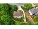 Aerial view of a home with a deck and manicured lawn, nestled among mature trees at 133 37Th Avenue Nw Pl, Hickory, NC 28601