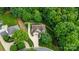 Aerial view showcases a well-maintained home with lush landscaping, mature trees, and winding driveway at 133 37Th Avenue Nw Pl, Hickory, NC 28601